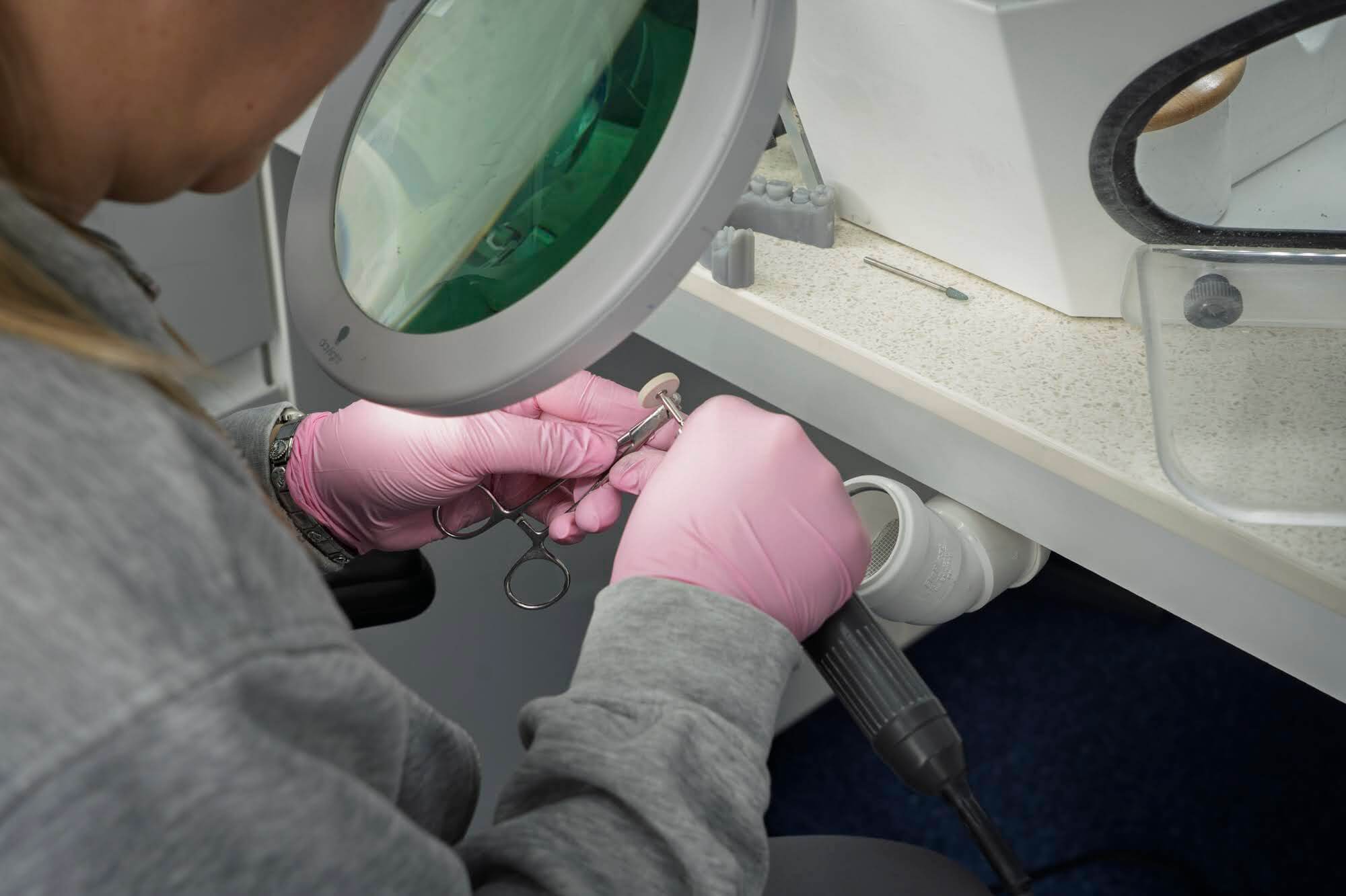 Finishing a dental appliance under magnification