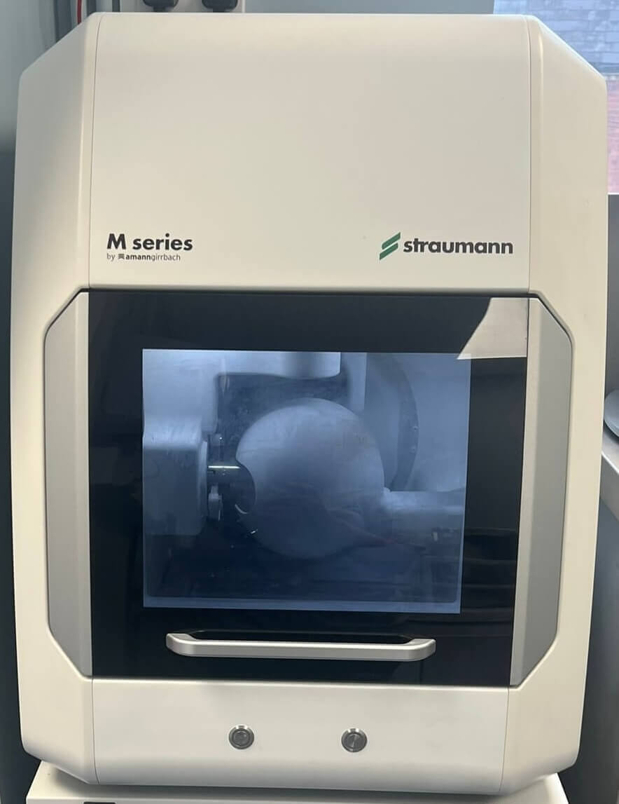 Straumann M Series milling machine cutting a zirconia restoration